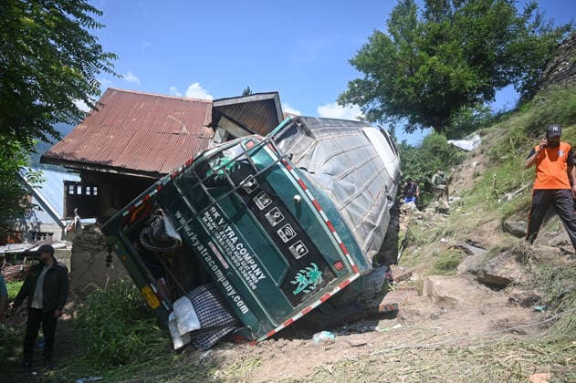 GANDERBAL, INDIA - JULY 28: A heavily damaged bus carrying Amarnath Yatra pilgrims rests along a steep embankment after skidding off the road and plunging into a deep gorge at the S-Mode stretch near Hariganiwan in the Gund area on July 28, 2026 in Ganderbal, India. The bus carrying around 40 pilgrims returning from the Baltal base camp toward Srinagar after performing darshan at the holy cave shrine, lost control while negotiating a treacherous curve. At least 39 pilgrims hailing from Madhya Pradesh, Rajasthan, and Delhi sustained injuries in the crash, which brought a swift multi-agency rescue operations. (Photo by Waseem Andrabi Hindustan Times) 39 Injured After Bus Carrying Amarnath Pilgrims Skids In Ganderbal