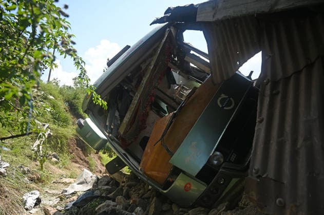 GANDERBAL, INDIA - JULY 28: A heavily damaged bus carrying Amarnath Yatra pilgrims rests along a steep embankment after skidding off the road and plunging into a deep gorge at the S-Mode stretch near Hariganiwan in the Gund area on July 28, 2026 in Ganderbal, India. The bus carrying around 40 pilgrims returning from the Baltal base camp toward Srinagar after performing darshan at the holy cave shrine, lost control while negotiating a treacherous curve. At least 39 pilgrims hailing from Madhya Pradesh, Rajasthan, and Delhi sustained injuries in the crash, which brought a swift multi-agency rescue operations. (Photo by Waseem Andrabi Hindustan Times) 39 Injured After Bus Carrying Amarnath Pilgrims Skids In Ganderbal