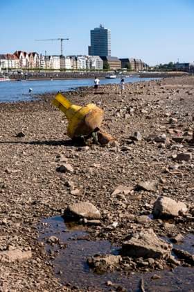 Boje auf Grund, Rhein bei Düsseldorf, extremes Niedrigwasser, Rheinpegel bei 31 cm, Tendenz fallend, nach der langen Dürre fällt das linke Rheinufer, bei Düsseldorf Oberkassel trocken, eine große Sandbank entsteht, Frachtschiffe können nur noch mit deutlich reduzierter Ladung fahren, Skyline der City, Oberkassler Rheinbrücke NRW, Deutschland Niedrigwasser Rhein *** Buoy aground, Rhine near Düsseldorf, extremely low water levels, Rhine water level at 31 cm, trending downward; following the long drought, the left bank of the Rhine near Düsseldorf-Oberkassel has dried up, a large sandbar has formed, cargo ships can now only navigate with significantly reduced cargo, city skyline, Oberkassel Rhine Bridge, North Rhine-Westphalia, Germany,