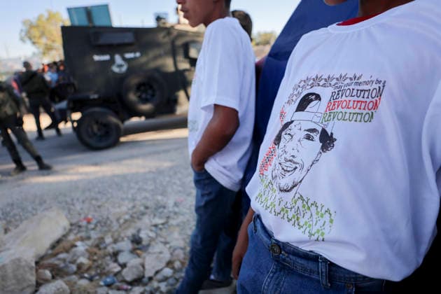 Hebron West Bank Umm Al Khair Memorial A participant wears a shirt bearing a portrait of Palestinian activist Odeh Al-Hathaleen and the repeated word Revolution in the village of Umm al-Khair, in Masafer Yatta, south of Hebron in the occupied West Bank, on July 28, 2026. Al-Hathaleen was killed on July 28, 2025, during a confrontation involving Israeli settlers in Umm al-Khair, and local witnesses said Israeli forces assaulted Israeli Knesset member Ofer Cassif during the anniversary incident. Hebron West Bank Palestinian Territories Copyright: xMosabxShawerx