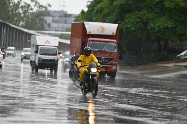 GURUGRAM, INDIA - JULY 28: Commuters make their way through rain showers on Sheetla Mata Road near Sukhrali Chowk on July 28, 2026 in Gurugram, India. (Photo by Parveen Kumar Hindustan Times) Heavy Rains Inundates Gurugram