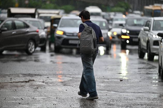 GURUGRAM, INDIA - JULY 28: Commuters make their way through rain showers on Sheetla Mata Road near Sukhrali Chowk on July 28, 2026 in Gurugram, India. (Photo by Parveen Kumar Hindustan Times) Heavy Rains Inundates Gurugram