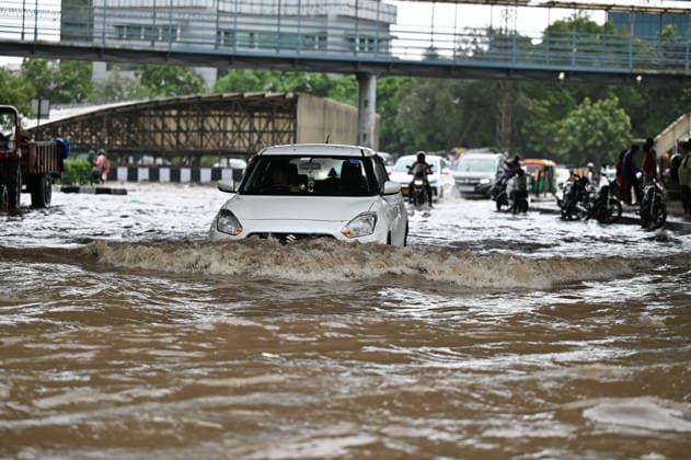GURUGRAM, INDIA - JULY 28: Vehicles wade through a waterlogged stretch during rain on the National Highway-48 near Signature Tower Chowk on July 28, 2026 in Gurugram, India. (Photo by Parveen Kumar Hindustan Times) Heavy Rains Inundates Gurugram