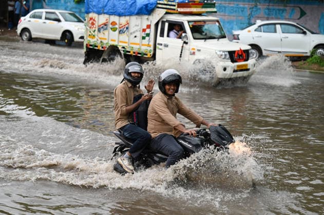 GURUGRAM, INDIA - JULY 28: Vehicles wade through a waterlogged stretch during rain on the National Highway-48 near Signature Tower Chowk on July 28, 2026 in Gurugram, India. (Photo by Parveen Kumar Hindustan Times) Heavy Rains Inundates Gurugram