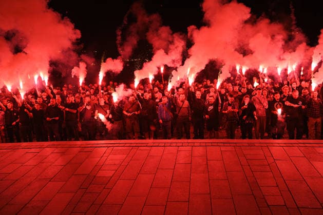 People hold burning flares in Maidan Nezalezhnosti Square during a commemorative ceremony marking the fourth anniversary of the Olenivka prison massacre, Kyiv, Ukraine, July 28, 2026. On the night of 28–29 July 2022, at least 53 Ukrainian prisoners of war were killed and more than 130 wounded in a Russian terrorist attack on the former Volnovakha Penal Colony No. 120 near the occupied settlement of Olenivka, Donetsk region, where defenders of Azovstal in Mariupol were being held. (Photo by Yevhen Kotenko Ukrinform) Kyiv remembers Olenivka prison massacre victims  Copyright: xYevhenxKotenkox