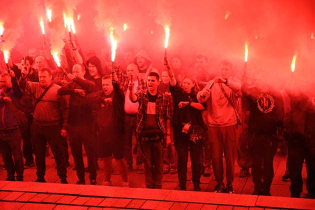 People hold burning flares in Maidan Nezalezhnosti Square during a commemorative ceremony marking the fourth anniversary of the Olenivka prison massacre, Kyiv, Ukraine, July 28, 2026. On the night of 28–29 July 2022, at least 53 Ukrainian prisoners of war were killed and more than 130 wounded in a Russian terrorist attack on the former Volnovakha Penal Colony No. 120 near the occupied settlement of Olenivka, Donetsk region, where defenders of Azovstal in Mariupol were being held. (Photo by Yevhen Kotenko Ukrinform) Kyiv remembers Olenivka prison massacre victims  Copyright: xYevhenxKotenkox