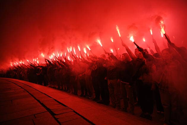 People hold burning flares in Maidan Nezalezhnosti Square during a commemorative ceremony marking the fourth anniversary of the Olenivka prison massacre, Kyiv, Ukraine, July 28, 2026. On the night of 28–29 July 2022, at least 53 Ukrainian prisoners of war were killed and more than 130 wounded in a Russian terrorist attack on the former Volnovakha Penal Colony No. 120 near the occupied settlement of Olenivka, Donetsk region, where defenders of Azovstal in Mariupol were being held. (Photo by Yevhen Kotenko Ukrinform) Kyiv remembers Olenivka prison massacre victims  Copyright: xYevhenxKotenkox