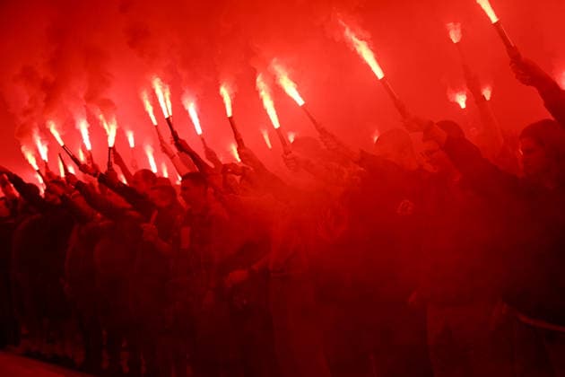 People hold burning flares in Maidan Nezalezhnosti Square during a commemorative ceremony marking the fourth anniversary of the Olenivka prison massacre, Kyiv, Ukraine, July 28, 2026. On the night of 28–29 July 2022, at least 53 Ukrainian prisoners of war were killed and more than 130 wounded in a Russian terrorist attack on the former Volnovakha Penal Colony No. 120 near the occupied settlement of Olenivka, Donetsk region, where defenders of Azovstal in Mariupol were being held. (Photo by Yevhen Kotenko Ukrinform) Kyiv remembers Olenivka prison massacre victims  Copyright: xYevhenxKotenkox