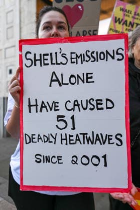 Fossil Free London Protest in UK - 29 Jul 2026 A member of the campaign group Fossil Free London holds a placard during a demonstration outside Shell s headquarters in London to highlight the role of fossil fuel production in climate change and its contribution to the increasing risk of wildfires across Europe. Campaigners from Fossil Free London staged a protest outside Shell Centre, Shell’s headquarters in London. During the demonstration, one participant dressed as a firefighter was covered in a black liquid resembling oil. Behind them, a banner read World on Fire, while placards displayed the messages Shell Fuels Wildfires and Oil Fuels Wildfires . London United Kingdom Copyright: xJamesxWilloughbyx xSOPAxImagesx JWILLOUGHBY_3099