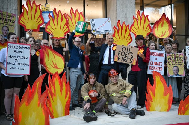 July 29, 2026, London, Lambeth, United Kingdom: Members of the campaign group Fossil Free London held a demonstration outside Shell s headquarters in London to highlight the impact of fossil fuel production on climate change and the increasing risk of wildfires across Europe. Campaigners from Fossil Free London staged a protest outside Shell Centre, Shell™s headquarters in London. During the demonstration, one participant dressed as a firefighter was covered in a black liquid resembling oil. Behind them, a banner read World on Fire, while placards displayed the messages Shell Fuels Wildfires and Oil Fuels Wildfiresâ London United Kingdom - ZUMAs197 20260729_aaa_s197_003 Copyright: xJamesxWilloughbyx