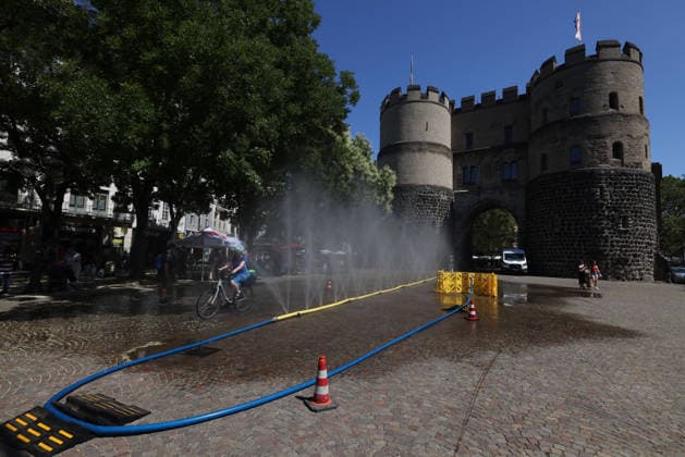 Cologne unveils cooling mist initiative as heatwave grips Germany COLOGNE, GERMANY - JULY 29: People try to cool off at Rudolfplatz Square during the Cooling Cologne initiative, where chilled groundwater was dispersed through fine mist sprays connected to fire hoses in Cologne, Germany on July 29, 2026. Organizers said the system lowered the surrounding temperature by about 12 degrees Celsius, offering relief as a heatwave swept across the region. Kadir Ilboga Anadolu Cologne Germany. Editorial use only. Please get in touch for any other usage.  Copyright: x2026xAnadoluxKadirxIlbogax