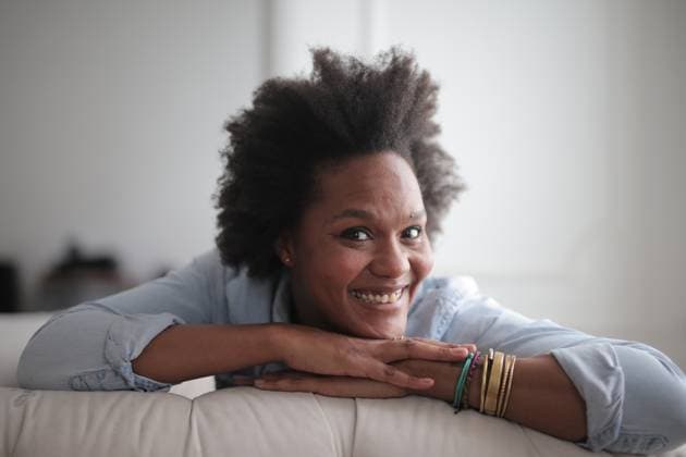 Happy black woman with natural hair relaxing at home Budapest, Hungary R_MIPI26072862-2088431-01 ,model released, Symbolfoto ,property released