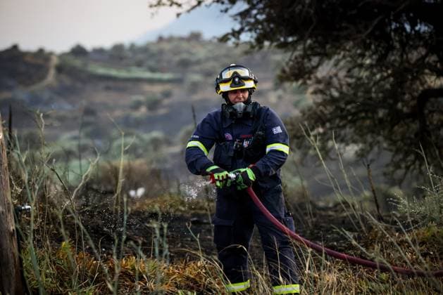 (260730) -- CRETE, July 30, 2026 -- A firefighter takes part in firefighting operations in Rethymno on the island of Crete, Greece, July 29, 2026. Two firefighters lost their lives while battling a fast-moving wildfire in Rethymno on the Greek island of Crete on Wednesday, as gale-force winds fueled the blaze across a front stretching more than 15 kilometers. (Photo by Xinhua) GREECE-CRETE-WILDFIRE-FIREFIGHTERS RapanisxSpiros 