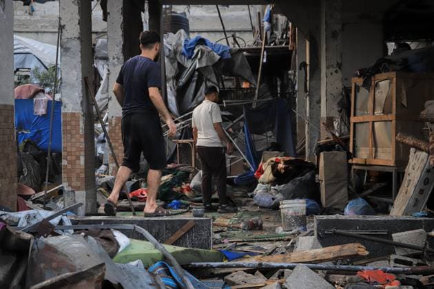 Palestinians inspect damaged homes after Israeli airstrike in Gaza City GAZA CITY, PALESTINE JULY 30, 2026: Palestinians inspect damaged homes following an Israeli airstrike that struck the Shamia family house overnight in Gaza City, causing extensive destruction to the targeted building and damage to neighboring homes amid the ongoing war in the Gaza Strip. Gaza Palestine, State of Copyright: x xMohammedxMxSkaikx xJNAxPressx