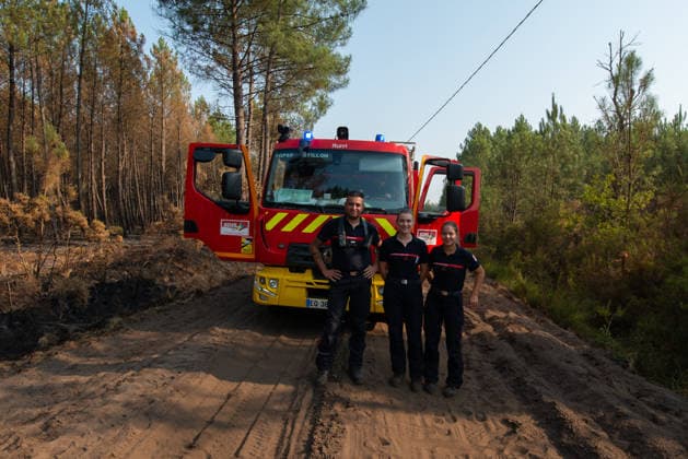 Wildfire Near Le Temple - Gironde Three firefighters pose in front of a fire engine during a brief pause in wildfire suppression operations near Le Temple, Gironde, southwestern France, on July 29, 2026. The surrounding forest bears the marks of the fire as crews continue working to contain the blaze.  Copyright: xSaptexFabrice ABACAx