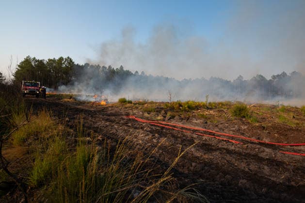 Wildfire Near Le Temple - Gironde Smoke drifts across a scorched landscape as firefighters continue wildfire suppression operations near Le Temple, Gironde, southwestern France, on July 29, 2026. Burned ground, active hotspots and fire hoses mark the fire line as crews work to secure the perimeter and extinguish remaining flames.  Copyright: xSaptexFabrice ABACAx