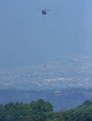 Firefighters battle wildfire in Mugla from air and ground MUGLA, TURKIYE - JULY 30 : Fire extinguishing efforts continue both from the air and land to contain a wildfire in the Seydikemer district of Mugla, Turkiye on July 30, 2026. Mahmut Serdar Alakus Anadolu Mugla Turkey. Editorial use only. Please get in touch for any other usage.  Copyright: x2026xAnadoluxMahmutxSerdarxAlakusx