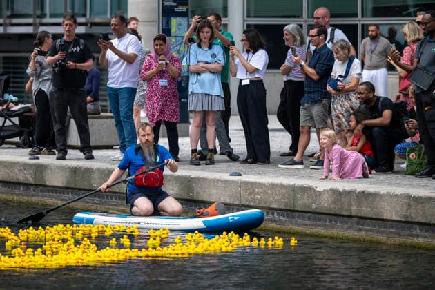 July 30, 2026, London, London, UK: LONDON, UK. Staff with leaf blowers and paddles coax three thousand sponsored rubber ducks to the finish of a charity rubber duck race in Merchant Square, Paddington Basin, raising funds for the paediatric intensive care unit at St MaryÃ¢â‚¬â ¢s Hospital through the charity COSMIC (Children of St Mary Intensive Care). Each duck has been sponsored by a member of the public. London UK  - ZUMAl94_ 20260730_zaf_l94_060 Copyright: xStephenxChungx