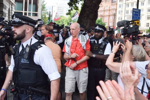 July 30, 2026, London, England, United Kingdom: Police officers make arrests as pro-Palestine protesters gather outside Westminster Magistrates Court during the so-called Graduation Day protest organised by Defend Our Juries. Police reportedly made arrests on unspecified charges as well as alleged support for the activist group Palestine Action, which is proscribed in the UK. London United Kingdom  - ZUMAv130 20260730_zip_v130_025 Copyright: xVukxValcicx