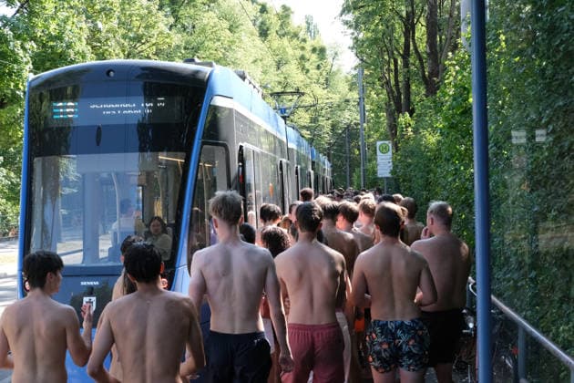 Munich residents ride trams in swimwear after cooling off in Eisbach, a summer routine in the city MUNICH, GERMANY - JULY 30: People in swimwear wait to board a tram at the Tivolistrasse stop after cooling off in the Eisbach river, as Munich residents traditionally do in summer, in Munich, Germany, on July 30, 2026. Munich records its hottest July 30 since 1947. Merve Goettl Anadolu Munich Germany. Editorial use only. Please get in touch for any other usage.  Copyright: x2026xAnadoluxMervexGoettlx