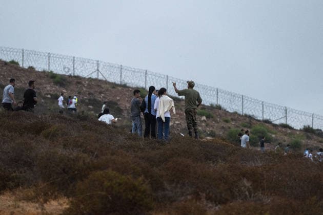 More than 800 irregular migrants intercepted while attempting to swim from Morocco to Spain s North African coast CASTILLEJOS, MOROCCO - JULY 31: Irregular migrants gather near the border area as more than 800 migrants attempting to swim from the coast of Castillejos, Morocco, to the Spanish North African enclave of Ceuta are intercepted by authorities on July 31, 2026. Some migrants are seen rushing toward the border in an attempt to enter Spanish territory. Abu Adem Muhammed Anadolu Castillejos Morocco. Editorial use only. Please get in touch for any other usage.  Copyright: x2026xAnadoluxAbuxAdemxMuhammedx