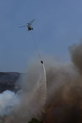 Firefighting efforts continue in Aydin AYDIN, TURKIYE - JULY 31: A firefighting helicopter drops water over a forested area as aerial and ground crews continue battling a wildfire in the Cine district of Aydin, on July 31, 2026 in Aydin, Turkiye. Yusuf Konrat Anadolu Aydin Turkey. Editorial use only. Please get in touch for any other usage.  Copyright: x2026xAnadoluxYusufxKonratx