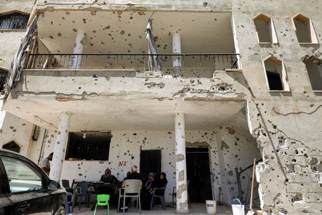 July 31, 2026, Zawtar Al-Gharbieh, Zawtar Al-Gharbieh, Lebanon: A Lebanese family sit in the shadow of their bullet riddled and shell-pocked building in the southern Lebanese village of Zawatar al-Gharbieh. Civilians started returning slowly the devastated hamlet after the army deployed inside the village following an Israeli withdrawal from several points inside it. Zawtar Al-Gharbieh Lebanon - ZUMAn313 20260731_zip_n313_006 Copyright: xMarwanxNaamanix