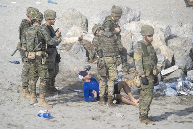 Migrants arrive on shore after attempting sea crossing to Ceuta from Morocco CEUTA, SPAIN - JULY 31: Spanish security forces take measures as migrants arrive on the shore of the Spanish city of Ceuta in North Africa after attempting to swim from Morocco on July 31, 2026. Moroccan and Algerian migrants attempted to reach Ceuta by sea, while many were intercepted by Moroccan patrol boats. Spain s Maritime Rescue Service, the Spanish Red Cross, and the Civil Guard carried out rescue operations after the attempted crossings. Marcos Moreno Anadolu Ceuta Spain. Editorial use only. Please get in touch for any other usage.  Copyright: x2026xAnadoluxMarcosxMorenox