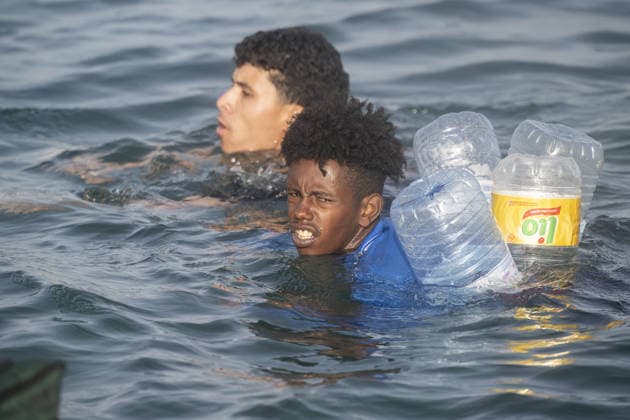 Migrants arrive on shore after attempting sea crossing to Ceuta from Morocco CEUTA, SPAIN - JULY 31: Migrants arrive on the shore of the Spanish city of Ceuta in North Africa after attempting to swim from Morocco on July 31, 2026. Moroccan and Algerian migrants attempted to reach Ceuta by sea, while many were intercepted by Moroccan patrol boats. Spain s Maritime Rescue Service, the Spanish Red Cross, and the Civil Guard carried out rescue operations after the attempted crossings. Marcos Moreno Anadolu Ceuta Spain. Editorial use only. Please get in touch for any other usage.  Copyright: x2026xAnadoluxMarcosxMorenox