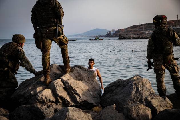 July 31, 2026, Ceuta, Spain: CEUTA, SPAIN Ã¢â‚¬ JULY 31 2026: Migrants gather near the Tarajal border crossing in Ceuta as Spanish security forces monitor the area during the afternoon. Ceuta Spain  - ZUMAq101 20260731_zna_q101_180 Copyright: xSamuelxVegax