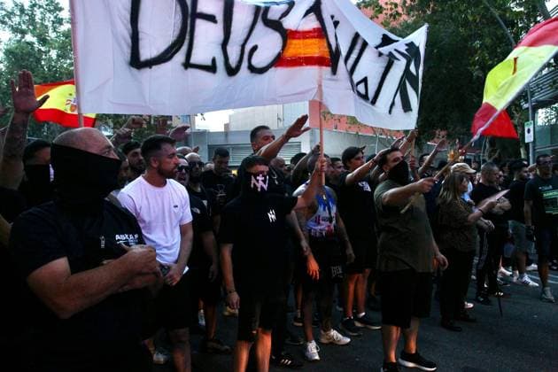 July 31, 2026, Barcelona, Spain: BARCELONA, SPAIN Ã¢â‚¬ JULY 31, 2026: Participants attend a demonstration outside the Moroccan Embassy in Barcelona following recent migration developments at Spain s North African enclave of Ceuta. Demonstrators wave Spanish flags, display banners and chant slogans during the protest, while some participants are seen making gestures commonly associated with Nazi salutes. Barcelona Spain - ZUMAq101 20260731_zna_q101_199 Copyright: xPabloxCarvajalxMunizagax