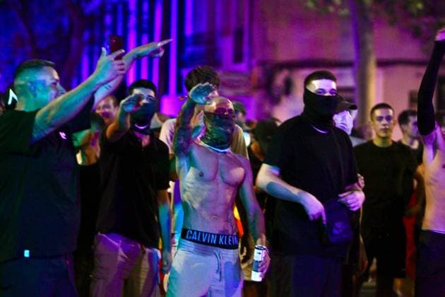 July 31, 2026, Barcelona, Spain: BARCELONA, SPAIN Ã¢â‚¬ JULY 31, 2026: Participants attend a demonstration outside the Moroccan Embassy in Barcelona following recent migration developments at Spain s North African enclave of Ceuta. Demonstrators wave Spanish flags, display banners and chant slogans during the protest, while some participants are seen making gestures commonly associated with Nazi salutes. Barcelona Spain - ZUMAq101 20260731_zna_q101_204 Copyright: xPabloxCarvajalxMunizagax