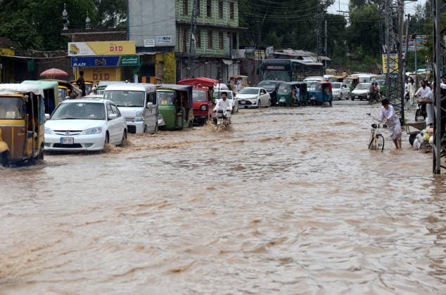July 31, 2026, Peshawar, Peshawar, Pakistan: Residents wade through flooded street as monsoon rains inundate Peshawar..People wade through a flooded street during heavy monsoon rain in Peshawar, Khyber Pakhtunkhwa province, Pakistan, on July 31, 2026. Pakistan s Meteorological Department (PMD) forecast the current monsoon spell to continue until August 5, warning of widespread rain, thunderstorms, heavy to very heavy downpours, and the risk of urban flooding, flash floods, landslides and river flooding across parts of the country. Peshawar Pakistan - ZUMAa217 20260731_znp_a217_001 Copyright: xHussainxAlix
