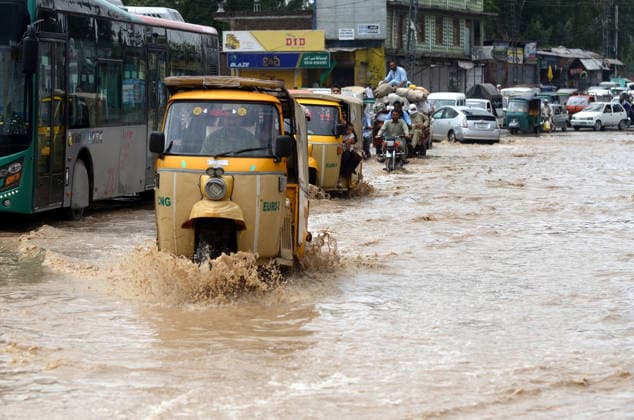 July 31, 2026, Peshawar, Peshawar, Pakistan: Residents wade through flooded street as monsoon rains inundate Peshawar..People wade through a flooded street during heavy monsoon rain in Peshawar, Khyber Pakhtunkhwa province, Pakistan, on July 31, 2026. Pakistan s Meteorological Department (PMD) forecast the current monsoon spell to continue until August 5, warning of widespread rain, thunderstorms, heavy to very heavy downpours, and the risk of urban flooding, flash floods, landslides and river flooding across parts of the country. Peshawar Pakistan - ZUMAa217 20260731_znp_a217_003 Copyright: xHussainxAlix