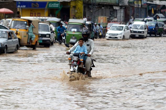 July 31, 2026, Peshawar, Peshawar, Pakistan: Residents wade through flooded street as monsoon rains inundate Peshawar..People wade through a flooded street during heavy monsoon rain in Peshawar, Khyber Pakhtunkhwa province, Pakistan, on July 31, 2026. Pakistan s Meteorological Department (PMD) forecast the current monsoon spell to continue until August 5, warning of widespread rain, thunderstorms, heavy to very heavy downpours, and the risk of urban flooding, flash floods, landslides and river flooding across parts of the country. Peshawar Pakistan  - ZUMAa217 20260731_znp_a217_005 Copyright: xHussainxAlix