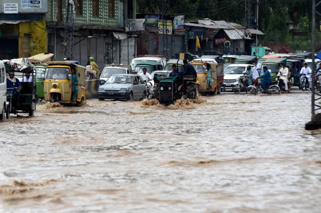 July 31, 2026, Peshawar, Peshawar, Pakistan: Residents wade through flooded street as monsoon rains inundate Peshawar..People wade through a flooded street during heavy monsoon rain in Peshawar, Khyber Pakhtunkhwa province, Pakistan, on July 31, 2026. Pakistan s Meteorological Department (PMD) forecast the current monsoon spell to continue until August 5, warning of widespread rain, thunderstorms, heavy to very heavy downpours, and the risk of urban flooding, flash floods, landslides and river flooding across parts of the country. Peshawar Pakistan  - ZUMAa217 20260731_znp_a217_006 Copyright: xHussainxAlix