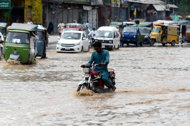 July 31, 2026, Peshawar, Peshawar, Pakistan: Residents wade through flooded street as monsoon rains inundate Peshawar..People wade through a flooded street during heavy monsoon rain in Peshawar, Khyber Pakhtunkhwa province, Pakistan, on July 31, 2026. Pakistan s Meteorological Department (PMD) forecast the current monsoon spell to continue until August 5, warning of widespread rain, thunderstorms, heavy to very heavy downpours, and the risk of urban flooding, flash floods, landslides and river flooding across parts of the country. Peshawar Pakistan  - ZUMAa217 20260731_znp_a217_007 Copyright: xHussainxAlix