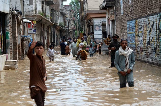 July 31, 2026, Peshawar, Peshawar, Pakistan: Residents wade through flooded street as monsoon rains inundate Peshawar..People wade through a flooded street during heavy monsoon rain in Peshawar, Khyber Pakhtunkhwa province, Pakistan, on July 31, 2026. Pakistan s Meteorological Department (PMD) forecast the current monsoon spell to continue until August 5, warning of widespread rain, thunderstorms, heavy to very heavy downpours, and the risk of urban flooding, flash floods, landslides and river flooding across parts of the country. Peshawar Pakistan  - ZUMAa217 20260731_znp_a217_008 Copyright: xHussainxAlix