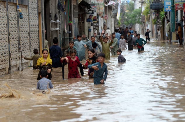 July 31, 2026, Peshawar, Peshawar, Pakistan: Residents wade through flooded street as monsoon rains inundate Peshawar..People wade through a flooded street during heavy monsoon rain in Peshawar, Khyber Pakhtunkhwa province, Pakistan, on July 31, 2026. Pakistan s Meteorological Department (PMD) forecast the current monsoon spell to continue until August 5, warning of widespread rain, thunderstorms, heavy to very heavy downpours, and the risk of urban flooding, flash floods, landslides and river flooding across parts of the country. Peshawar Pakistan  - ZUMAa217 20260731_znp_a217_011 Copyright: xHussainxAlix