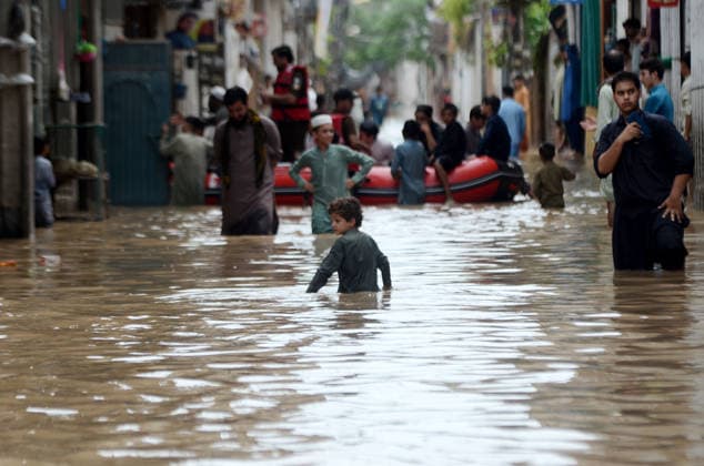 July 31, 2026, Peshawar, Peshawar, Pakistan: Residents wade through flooded street as monsoon rains inundate Peshawar..People wade through a flooded street during heavy monsoon rain in Peshawar, Khyber Pakhtunkhwa province, Pakistan, on July 31, 2026. Pakistan s Meteorological Department (PMD) forecast the current monsoon spell to continue until August 5, warning of widespread rain, thunderstorms, heavy to very heavy downpours, and the risk of urban flooding, flash floods, landslides and river flooding across parts of the country. Peshawar Pakistan - ZUMAa217 20260731_znp_a217_009 Copyright: xHussainxAlix