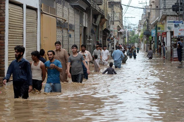 July 31, 2026, Peshawar, Peshawar, Pakistan: Residents wade through flooded street as monsoon rains inundate Peshawar..People wade through a flooded street during heavy monsoon rain in Peshawar, Khyber Pakhtunkhwa province, Pakistan, on July 31, 2026. Pakistan s Meteorological Department (PMD) forecast the current monsoon spell to continue until August 5, warning of widespread rain, thunderstorms, heavy to very heavy downpours, and the risk of urban flooding, flash floods, landslides and river flooding across parts of the country. Peshawar Pakistan - ZUMAa217 20260731_znp_a217_012 Copyright: xHussainxAlix