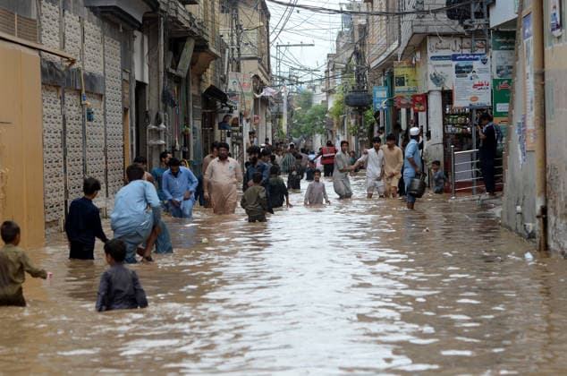July 31, 2026, Peshawar, Peshawar, Pakistan: Residents wade through flooded street as monsoon rains inundate Peshawar..People wade through a flooded street during heavy monsoon rain in Peshawar, Khyber Pakhtunkhwa province, Pakistan, on July 31, 2026. Pakistan s Meteorological Department (PMD) forecast the current monsoon spell to continue until August 5, warning of widespread rain, thunderstorms, heavy to very heavy downpours, and the risk of urban flooding, flash floods, landslides and river flooding across parts of the country. Peshawar Pakistan  - ZUMAa217 20260731_znp_a217_014 Copyright: xHussainxAlix
