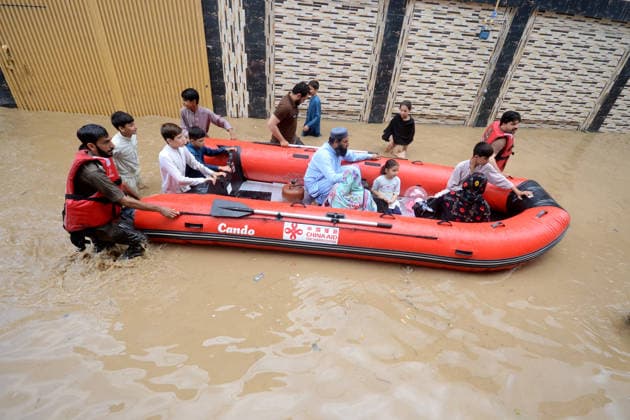 July 31, 2026, Peshawar, Peshawar, Pakistan: Residents wade through flooded street as monsoon rains inundate Peshawar..Caption:.People wade through a flooded street during heavy monsoon rain in Peshawar, Khyber Pakhtunkhwa province, Pakistan, on July 31, 2026. Pakistan s Meteorological Department (PMD) forecast the current monsoon spell to continue until August 5, warning of widespread rain, thunderstorms, heavy to very heavy downpours, and the risk of urban flooding, flash floods, landslides and river flooding across parts of the country. Peshawar Pakistan - ZUMAa217 20260731_znp_a217_019 Copyright: xHussainxAlix