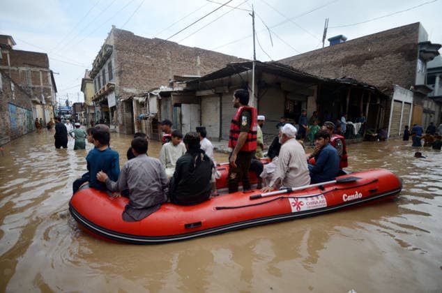 July 31, 2026, Peshawar, Peshawar, Pakistan: Residents wade through flooded street as monsoon rains inundate Peshawar..People wade through a flooded street during heavy monsoon rain in Peshawar, Khyber Pakhtunkhwa province, Pakistan, on July 31, 2026. Pakistan s Meteorological Department (PMD) forecast the current monsoon spell to continue until August 5, warning of widespread rain, thunderstorms, heavy to very heavy downpours, and the risk of urban flooding, flash floods, landslides and river flooding across parts of the country. Peshawar Pakistan - ZUMAa217 20260731_znp_a217_026 Copyright: xHussainxAlix