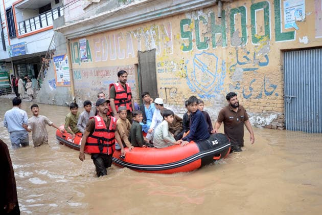 July 31, 2026, Peshawar, Peshawar, Pakistan: Residents wade through flooded street as monsoon rains inundate Peshawar..People wade through a flooded street during heavy monsoon rain in Peshawar, Khyber Pakhtunkhwa province, Pakistan, on July 31, 2026. Pakistan s Meteorological Department (PMD) forecast the current monsoon spell to continue until August 5, warning of widespread rain, thunderstorms, heavy to very heavy downpours, and the risk of urban flooding, flash floods, landslides and river flooding across parts of the country. Peshawar Pakistan  - ZUMAa217 20260731_znp_a217_028 Copyright: xHussainxAlix