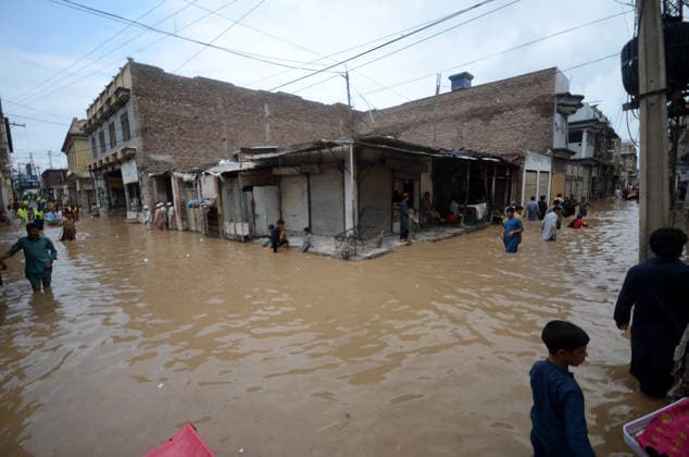 July 31, 2026, Peshawar, Peshawar, Pakistan: Residents wade through flooded street as monsoon rains inundate Peshawar..People wade through a flooded street during heavy monsoon rain in Peshawar, Khyber Pakhtunkhwa province, Pakistan, on July 31, 2026. Pakistan s Meteorological Department (PMD) forecast the current monsoon spell to continue until August 5, warning of widespread rain, thunderstorms, heavy to very heavy downpours, and the risk of urban flooding, flash floods, landslides and river flooding across parts of the country. Peshawar Pakistan - ZUMAa217 20260731_znp_a217_030 Copyright: xHussainxAlix