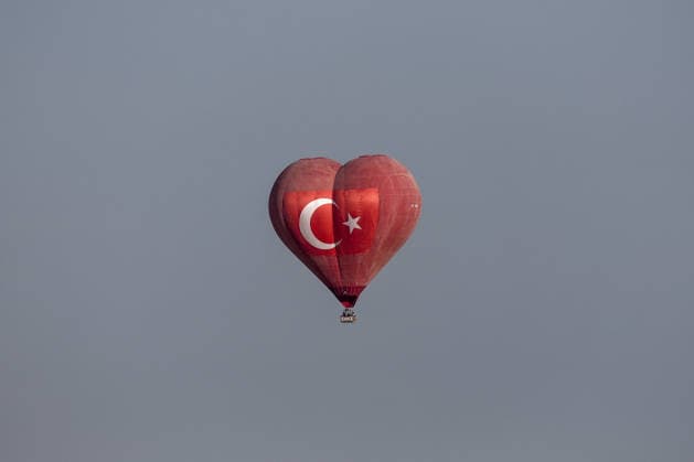 7th Cappadocia Balloon Festival NEVSEHIR, TURKIYE - AUGUST 01: A heart-shaped hot air balloon bearing the Turkish flag float above fairy chimneys during the seventh Cappadocia Balloon Festival, on August 01, 2026 in Nevsehir, Turkiye. Organized by the Ministry of Culture and Tourism, the festival features 30 specially designed balloons brought from Turkiye and several other countries. During sunrise demonstration flights over Goreme, balloons shaped like hearts, owls, parrots, rockets and the Earth attracted the attention of local and international visitors. Osmancan Gurdogan Anadolu Nevsehir Turkey. Editorial use only. Please get in touch for any other usage.  Copyright: x2026xAnadoluxOsmancanxGurdoganx