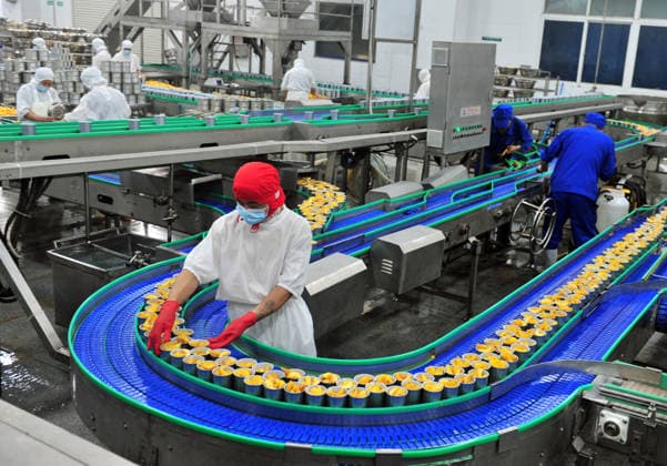 YICHANG, CHINA - AUGUST 01: Workers process yellow peaches on an automated production line at the fruit workshop of Qugu International Agriculture Group on August 1, 2026 in Zigui, Hubei Province of China.  Copyright: xVCGx 111657565619