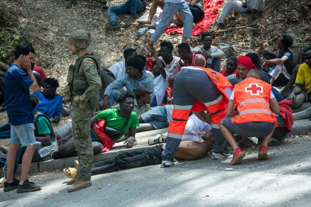 August 1, 2026, Ceuta, Ceuta, Spain: Red Cross members attend to migrants near the Temporary Stay Centre for Immigrants Ceuta Spain - ZUMAd308 20260801_zsp_d308_066 Copyright: xJuanxCarlosxLucasx