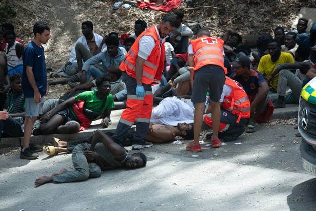 August 1, 2026, Ceuta, Ceuta, Spain: Red Cross members attend to migrants near the Temporary Stay Centre for Immigrants Ceuta Spain - ZUMAd308 20260801_zsp_d308_068 Copyright: xJuanxCarlosxLucasx